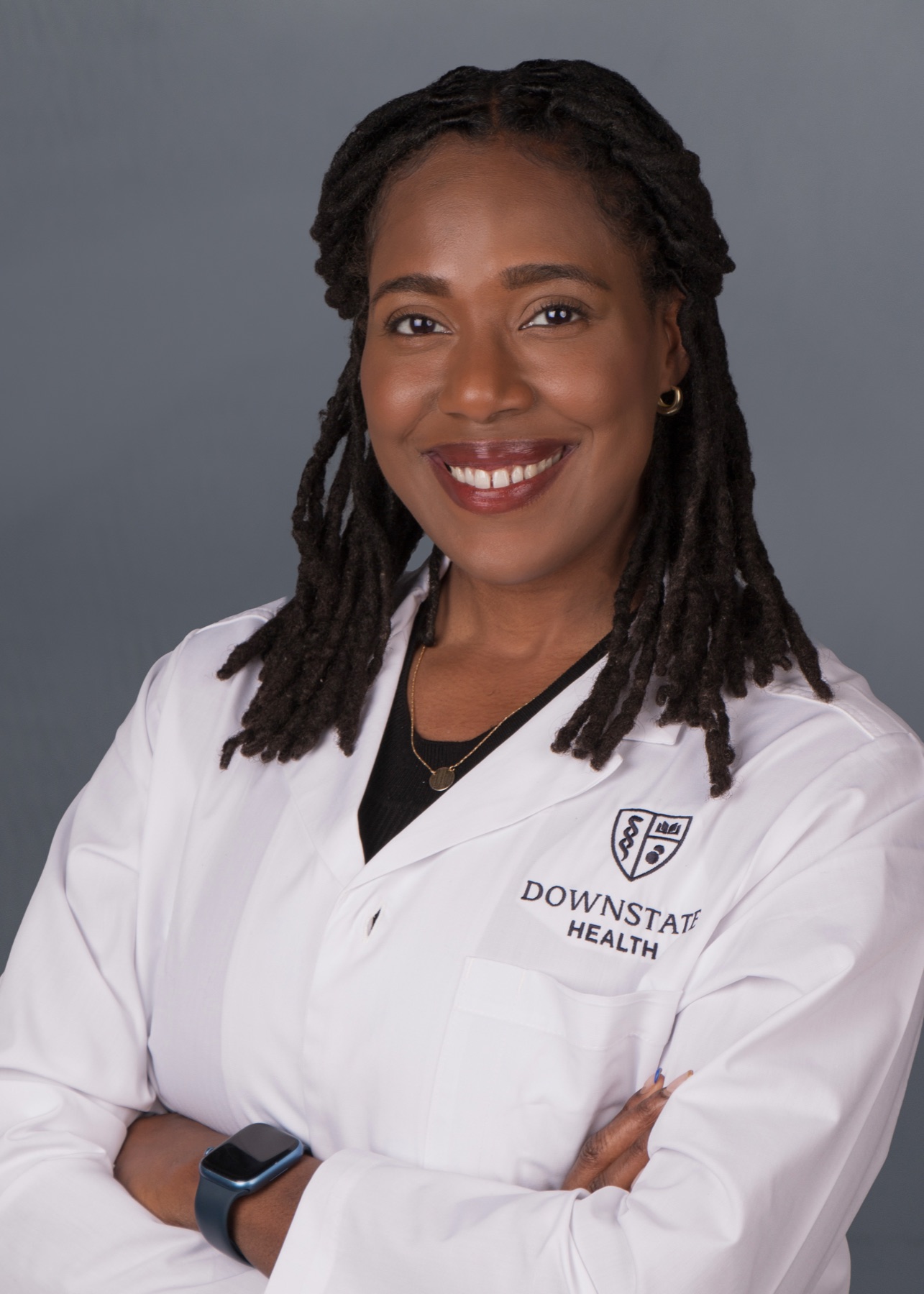 Dr. Laurenie Louissaint in a white coat